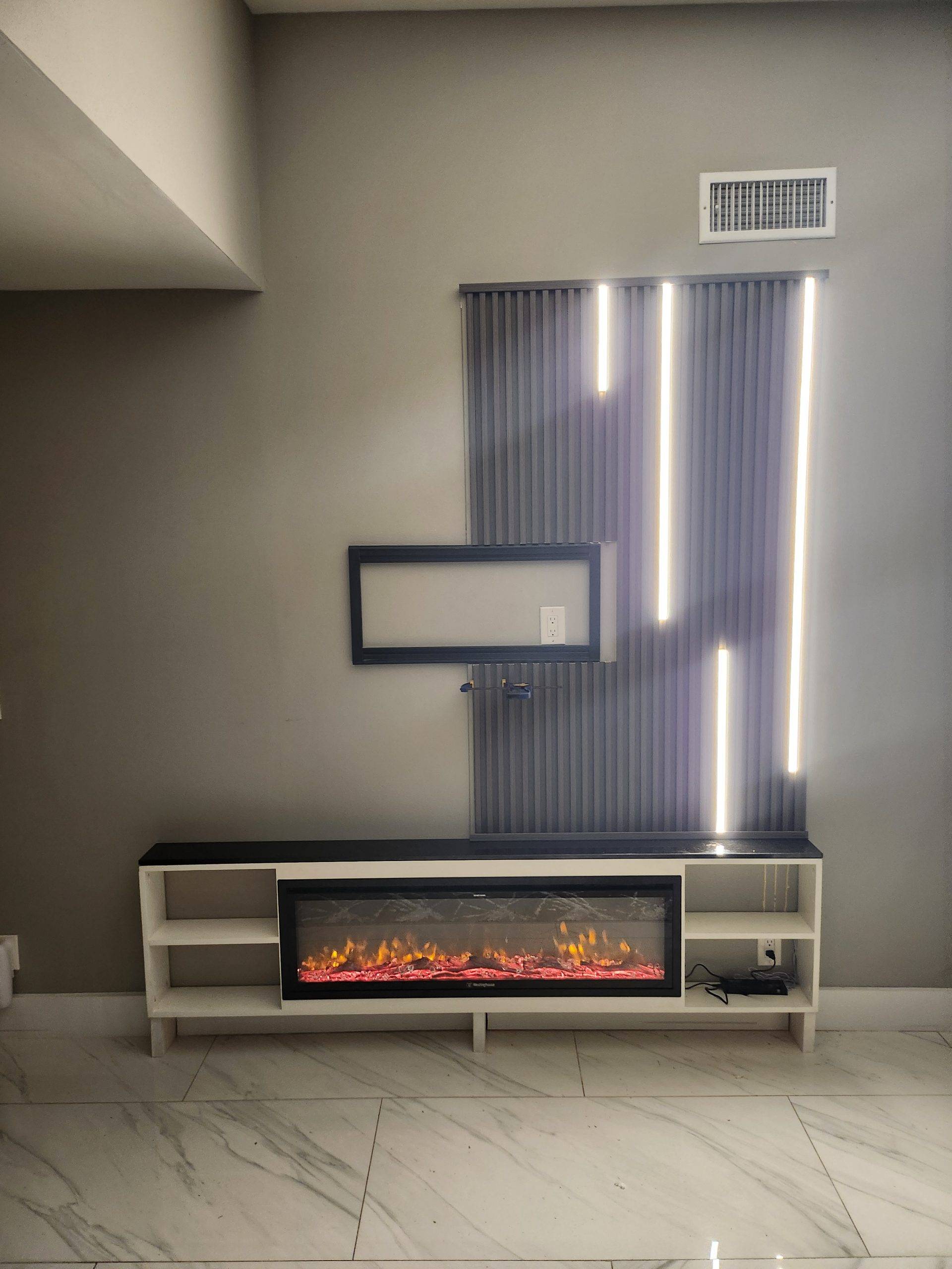 Living room media wall with slat paneling, LED accent lighting, and a built-in electric fireplace